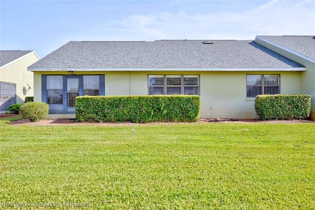 rear view of property featuring a yard