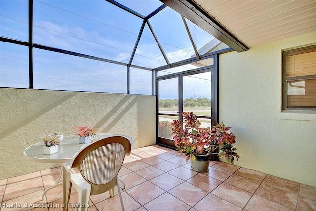 view of patio with glass enclosure