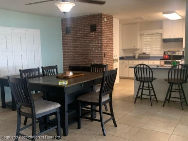 dining room featuring ceiling fan and light tile patterned floors