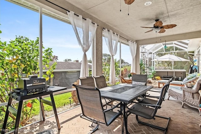 sunroom / solarium featuring ceiling fan