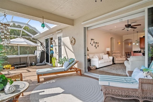 exterior space featuring outdoor lounge area, ceiling fan, a lanai, and a hot tub