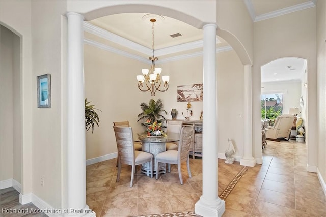 dining room with ornate columns, light tile patterned flooring, ornamental molding, a notable chandelier, and a raised ceiling