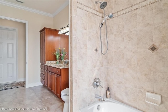 bathroom featuring crown molding, vanity, tile patterned floors, and tiled shower / bath