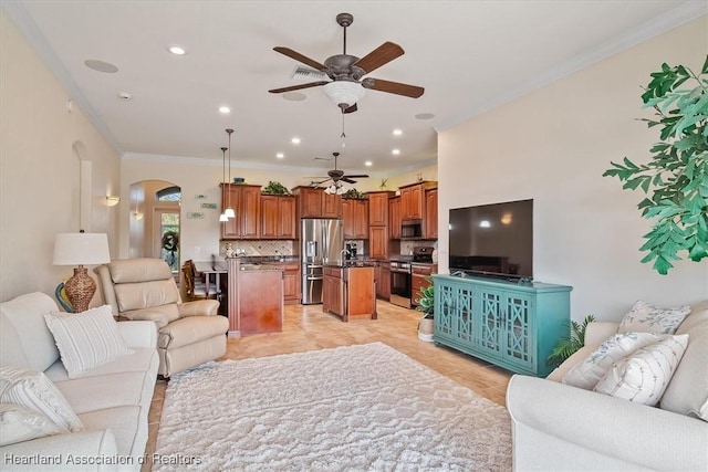 tiled living room featuring crown molding and ceiling fan