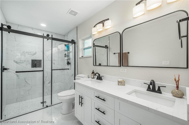 bathroom featuring tile patterned flooring, vanity, toilet, and an enclosed shower