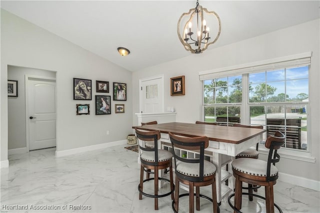 dining room featuring lofted ceiling and a notable chandelier