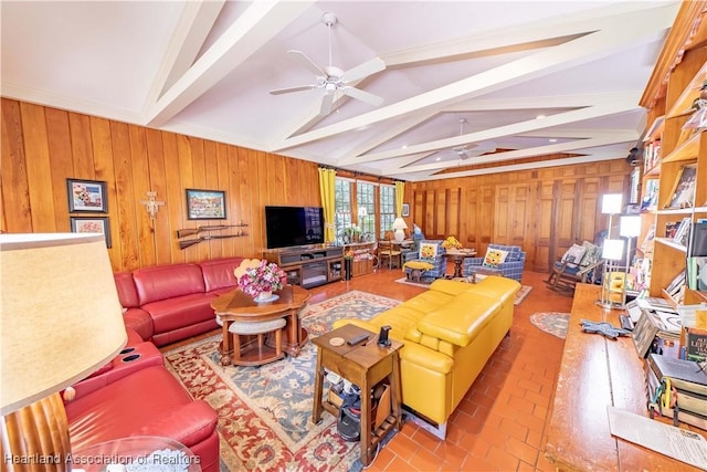 living room with vaulted ceiling with beams, ceiling fan, and wooden walls