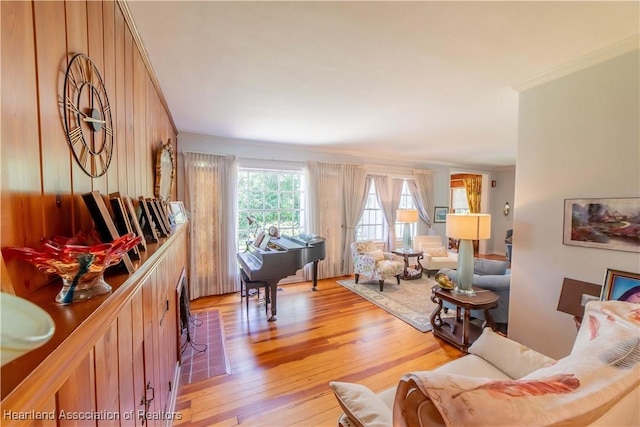 living room featuring light wood-type flooring and ornamental molding