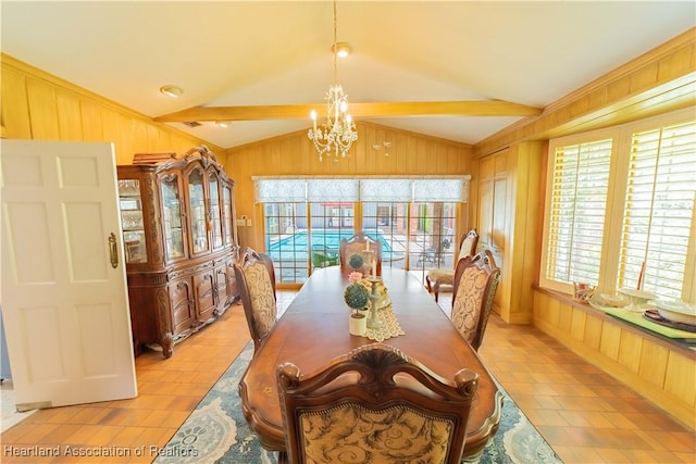 dining space featuring a notable chandelier and lofted ceiling