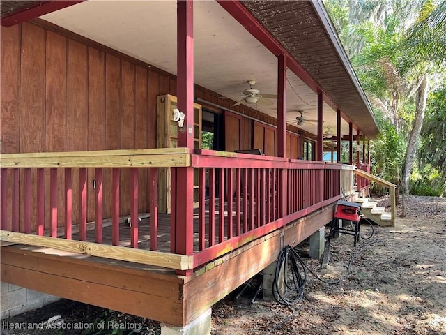 wooden terrace featuring a ceiling fan