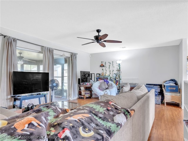 living room featuring light hardwood / wood-style flooring and a textured ceiling