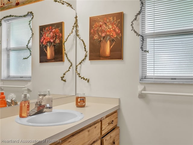 bathroom with plenty of natural light and vanity