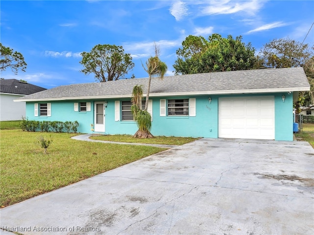 single story home featuring a garage and a front yard