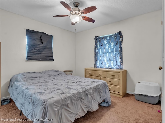 carpeted bedroom featuring a textured ceiling and ceiling fan