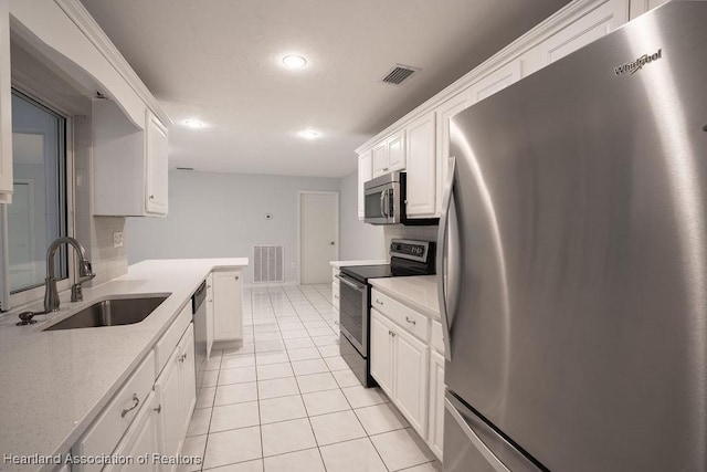 702 Catfish Rd, Lake Placid, FL 33852 - kitchen featuring appliances with stainless steel finishes, a sink, white cabinetry, light tile patterned flooring, and recessed lighting