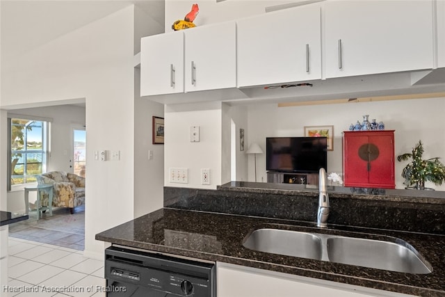 kitchen with white cabinets, dishwasher, a sink, and light tile patterned floors