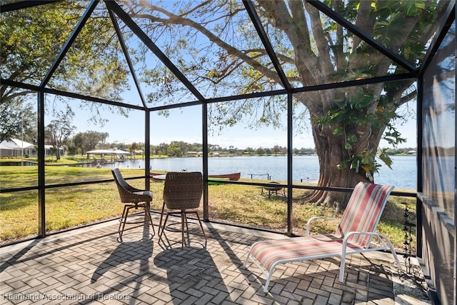 unfurnished sunroom featuring a water view