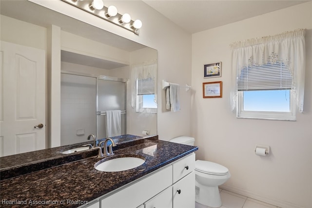 bathroom featuring baseboards, toilet, tile patterned floors, vanity, and a shower stall