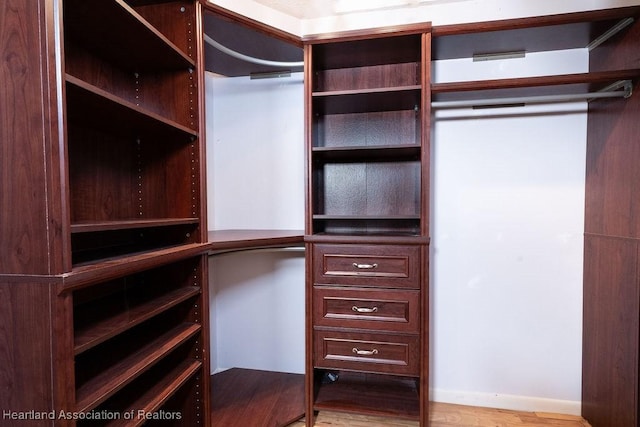 walk in closet featuring light hardwood / wood-style flooring