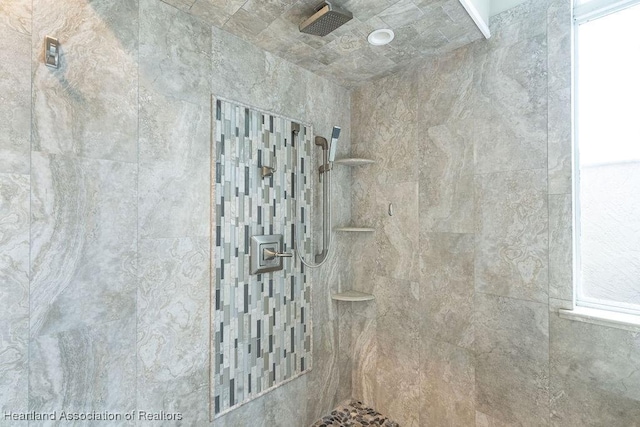 interior details with a tile shower