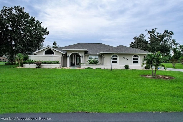 single story home featuring a front yard