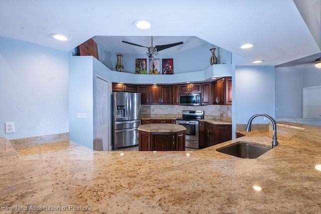 kitchen with a kitchen island, kitchen peninsula, sink, and appliances with stainless steel finishes