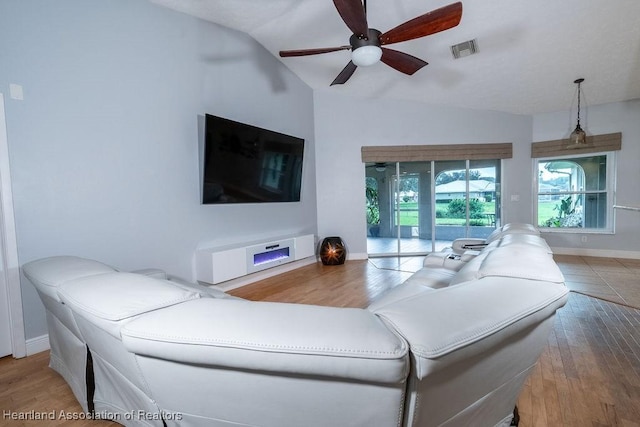 living room with ceiling fan, wood-type flooring, and lofted ceiling