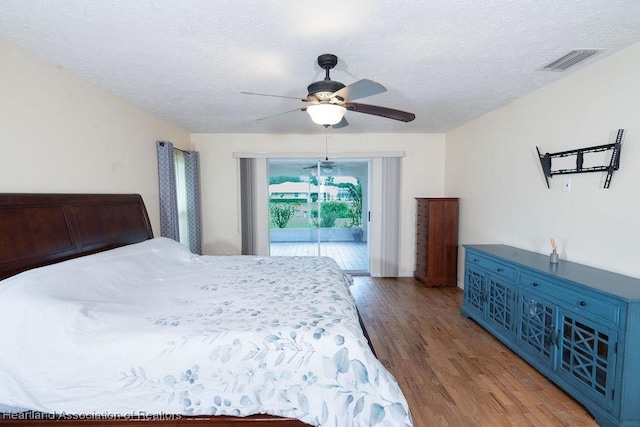 bedroom featuring wood-type flooring, a textured ceiling, access to outside, and ceiling fan