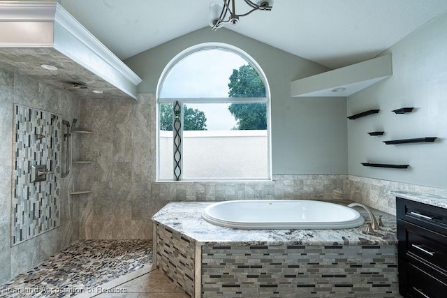 bathroom featuring tile patterned floors, plenty of natural light, vanity, and vaulted ceiling