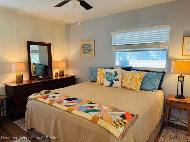 bedroom featuring ceiling fan and dark hardwood / wood-style flooring