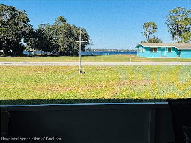 view of community with a yard and a water view