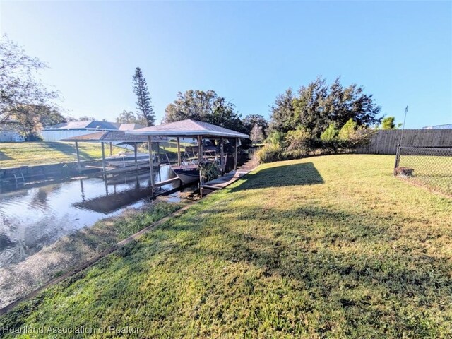 dock area featuring a yard and a water view