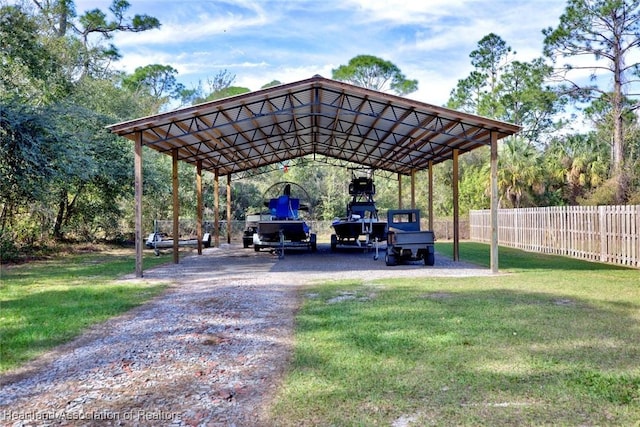 view of parking / parking lot featuring a yard and a carport