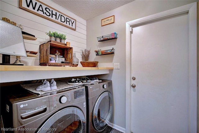 laundry room with washer and dryer and a textured ceiling