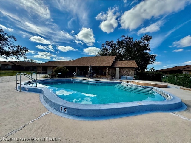 view of swimming pool with a patio area