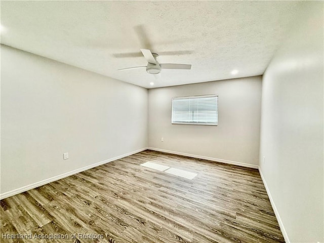 spare room featuring ceiling fan, hardwood / wood-style floors, and a textured ceiling