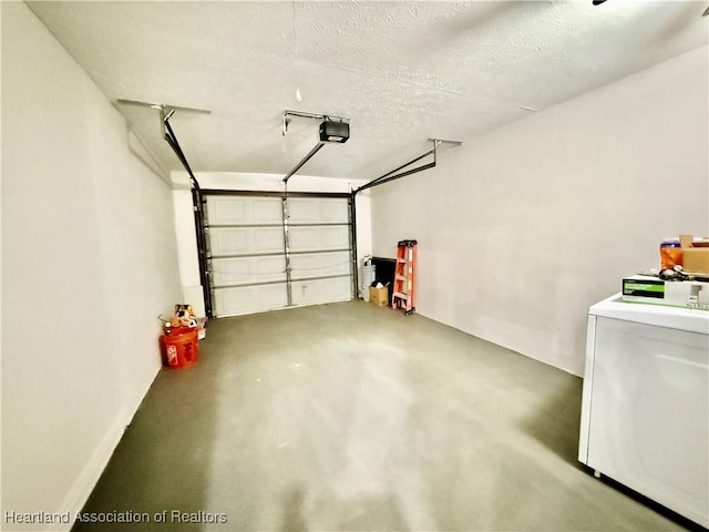 garage with a garage door opener and washer / dryer