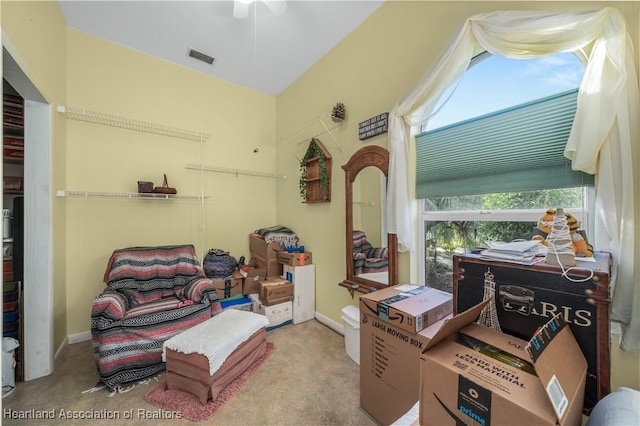 sitting room featuring carpet flooring, a ceiling fan, and visible vents