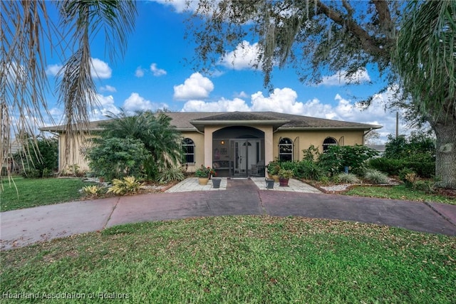 3534 Tubbs Rd, Sebring, FL 33870 - single story home with stucco siding, a front yard, and french doors