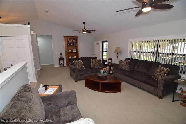 carpeted living room with ceiling fan and lofted ceiling