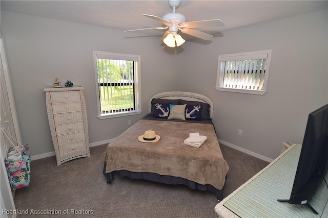 bedroom featuring dark colored carpet and ceiling fan