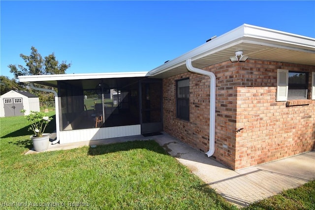 view of side of home featuring a sunroom and a yard