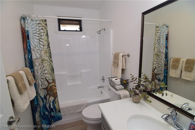 full bathroom featuring shower / tub combo with curtain, vanity, and toilet