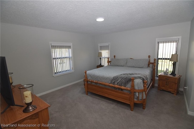 carpeted bedroom featuring a textured ceiling