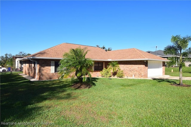 ranch-style home with a front yard and a garage