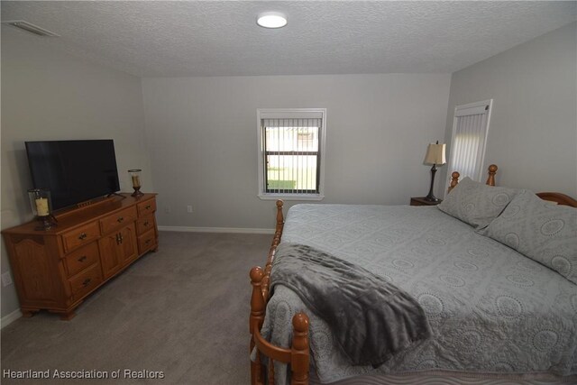 carpeted bedroom with a textured ceiling