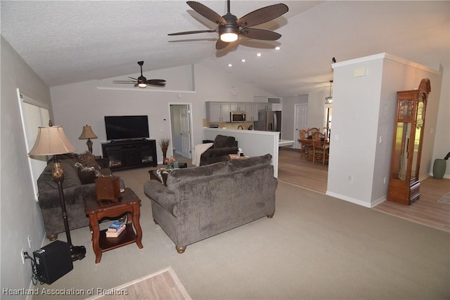 living room featuring light carpet, a textured ceiling, vaulted ceiling, and ceiling fan