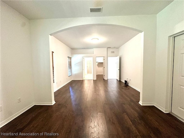 unfurnished room featuring dark wood-type flooring