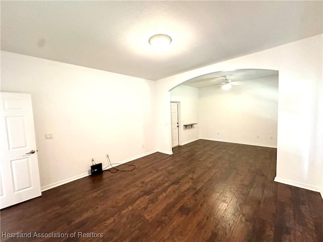 spare room featuring dark hardwood / wood-style floors and ceiling fan