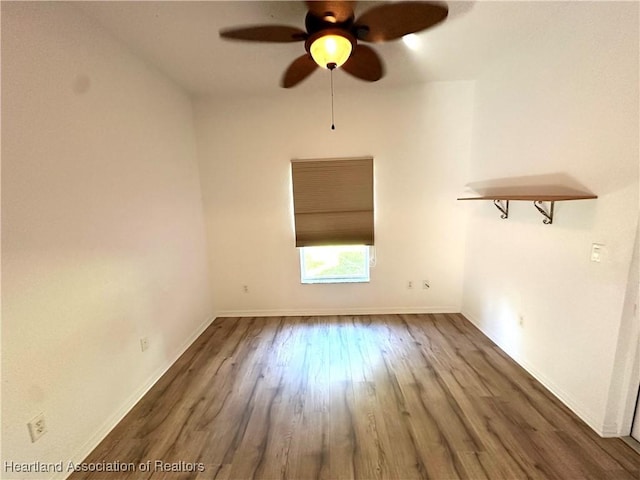 empty room featuring ceiling fan and dark wood-type flooring